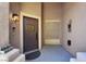 View of front door adorned with wreath, covered porch and exterior light fixture at 10805 Hollow Creek Ln, Las Vegas, NV 89144