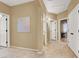 Hallway with neutral paint and tile, leading to other rooms at 10805 Hollow Creek Ln, Las Vegas, NV 89144