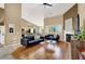 Open living room with fireplace, ceiling fan, and stylish decor at 10805 Hollow Creek Ln, Las Vegas, NV 89144