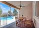 Covered patio area with outdoor dining set and a ceiling fan, perfect for entertaining at 10805 Hollow Creek Ln, Las Vegas, NV 89144