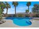 Enjoy the refreshing pool surrounded by lush landscaping and towering palm trees at 10805 Hollow Creek Ln, Las Vegas, NV 89144