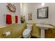Powder room featuring wainscoting, pedestal sink, framed mirror, and black and white mosaic tile flooring at 11477 Timber Mountain Ave, Las Vegas, NV 89135