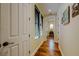 Hallway with hardwood floors, natural light, and neutral paint leading to the rest of the home at 11477 Timber Mountain Ave, Las Vegas, NV 89135