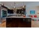 The kitchen boasts an island and stainless steel appliances, perfect for cooking and hosting at 11477 Timber Mountain Ave, Las Vegas, NV 89135