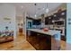 Spacious kitchen features dark wood cabinets, stainless steel appliances, and a center island at 11477 Timber Mountain Ave, Las Vegas, NV 89135