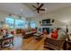 Spacious living room with hardwood floors, large windows, and comfortable seating at 11477 Timber Mountain Ave, Las Vegas, NV 89135