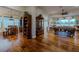 Open-concept living room with hardwood floors, seamless flow to dining area, and natural light at 11477 Timber Mountain Ave, Las Vegas, NV 89135