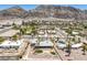 Expansive aerial view of a desert home featuring lush landscaping and mountain views at 1157 Morning Sun Way, Las Vegas, NV 89110