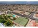 Expansive aerial view showcasing tennis courts, pool, RV parking, and community amenities near a residential neighborhood in Las Vegas at 1157 Morning Sun Way, Las Vegas, NV 89110