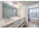 Bright bathroom featuring double sinks, quartz countertops, and sleek vanity lighting at 1157 Morning Sun Way, Las Vegas, NV 89110
