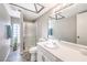 Bathroom with glass enclosed shower stall, single bowl sink, and wood look flooring at 1157 Morning Sun Way, Las Vegas, NV 89110