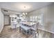 Bright dining area with a modern light fixture, white counter top and hardwood floors at 1157 Morning Sun Way, Las Vegas, NV 89110