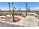 Desert landscaped driveway with palm trees and a well maintained garden and arched entry at 1157 Morning Sun Way, Las Vegas, NV 89110