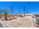 Wide driveway leading to a single-story home with desert landscaping and palm trees at 1157 Morning Sun Way, Las Vegas, NV 89110