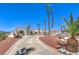 Long driveway and desert landscaping leads to an arched gated front entry at 1157 Morning Sun Way, Las Vegas, NV 89110