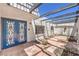Detailed courtyard featuring covered beam patio cover and decorative doors and window at 1157 Morning Sun Way, Las Vegas, NV 89110