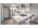 Well-lit modern kitchen with stainless steel appliances, white cabinets and bar top seating at 1157 Morning Sun Way, Las Vegas, NV 89110