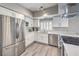 Modern kitchen featuring stainless steel appliances, granite countertops, and ample storage at 1157 Morning Sun Way, Las Vegas, NV 89110