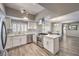 Open kitchen with stainless steel appliances, white cabinets, and a view of the dining area at 1157 Morning Sun Way, Las Vegas, NV 89110