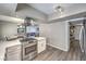 Bright kitchen with stainless steel range, white cabinets, and access to dining area at 1157 Morning Sun Way, Las Vegas, NV 89110