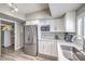 Well-lit modern kitchen with stainless steel appliances, white cabinets, and bar top seating at 1157 Morning Sun Way, Las Vegas, NV 89110