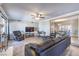 Comfortable living room with a ceiling fan, hardwood floors, and a view to the dining area at 1157 Morning Sun Way, Las Vegas, NV 89110