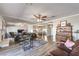 Spacious living room with hardwood floors, a ceiling fan, and plenty of natural light at 1157 Morning Sun Way, Las Vegas, NV 89110