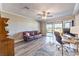 Inviting living room with ceiling fan, hardwood floors, and sliding glass doors with views at 1157 Morning Sun Way, Las Vegas, NV 89110