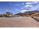 Expansive parking area with a variety of vehicles, stables, desert landscaping and mountain views at 1157 Morning Sun Way, Las Vegas, NV 89110