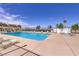 Community swimming pool with clear blue water, lounge chairs, and well-maintained landscaping at 1157 Morning Sun Way, Las Vegas, NV 89110