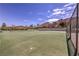 Community tennis court with green surface and desert mountain backdrop at 1157 Morning Sun Way, Las Vegas, NV 89110