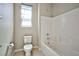 Clean bathroom featuring a toilet and tiled shower-tub combination at 1275 Ice Park St # 101, Las Vegas, NV 89135