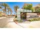 Community entrance featuring palm trees and modern signage at 1275 Ice Park St # 101, Las Vegas, NV 89135