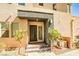 Contemporary home entrance with covered porch, stylish door, desert landscaping and house number display at 1275 Ice Park St # 101, Las Vegas, NV 89135
