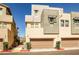 Modern townhome exterior with individual garages, desert landscaping and neutral color palette at 1275 Ice Park St # 101, Las Vegas, NV 89135