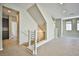 Bright foyer with modern railing staircase, tile floors and neutral paint at 1275 Ice Park St # 101, Las Vegas, NV 89135