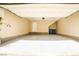 Spacious two car garage with sealed concrete floors, storage space, and rear entry door at 1275 Ice Park St # 101, Las Vegas, NV 89135