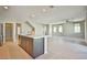Open-concept living area with island bar, tile flooring and modern staircase at 1275 Ice Park St # 101, Las Vegas, NV 89135