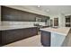 Modern kitchen with dark wood cabinets, stainless steel appliances, and a large center island at 1275 Ice Park St # 101, Las Vegas, NV 89135