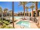 Resort-style community pool and spa surrounded by ample seating and lush landscaping at 1275 Ice Park St # 101, Las Vegas, NV 89135