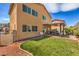 Spacious backyard showcasing a covered patio, grassy area, and easy access from the home at 1420 Gilbert Creek Ave, North Las Vegas, NV 89031