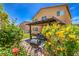 Landscaped backyard with covered patio, barbecue, and vibrant plants, perfect for outdoor living at 1420 Gilbert Creek Ave, North Las Vegas, NV 89031