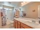 Bright bathroom featuring a spacious vanity and shower-tub combination at 1420 Gilbert Creek Ave, North Las Vegas, NV 89031