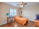 Inviting bedroom with a ceiling fan, hardwood floors, and plenty of natural light at 1420 Gilbert Creek Ave, North Las Vegas, NV 89031