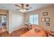 Charming bedroom with a ceiling fan, hardwood floors, and a comfortable workspace at 1420 Gilbert Creek Ave, North Las Vegas, NV 89031