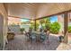 Outdoor dining under the covered patio with ample seating for relaxing and entertaining guests at 1420 Gilbert Creek Ave, North Las Vegas, NV 89031