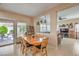 Light-filled dining room features a wooden table, backyard access, and a view into the living room at 1420 Gilbert Creek Ave, North Las Vegas, NV 89031
