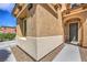 Home's entrance with textured walls, manicured gravel landscaping, and a walkway to the front door at 1420 Gilbert Creek Ave, North Las Vegas, NV 89031