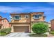 Two-story home featuring a tiled roof, a two-car garage, desert landscaping, and shuttered windows at 1420 Gilbert Creek Ave, North Las Vegas, NV 89031