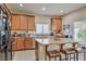 Kitchen features granite countertops, wood cabinets, stainless appliances, and a breakfast bar at 1420 Gilbert Creek Ave, North Las Vegas, NV 89031
